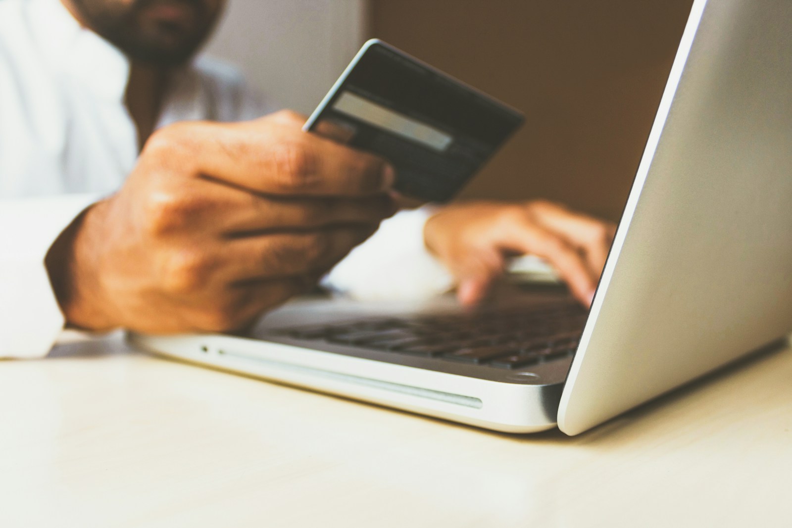Making a card payment at a laptop